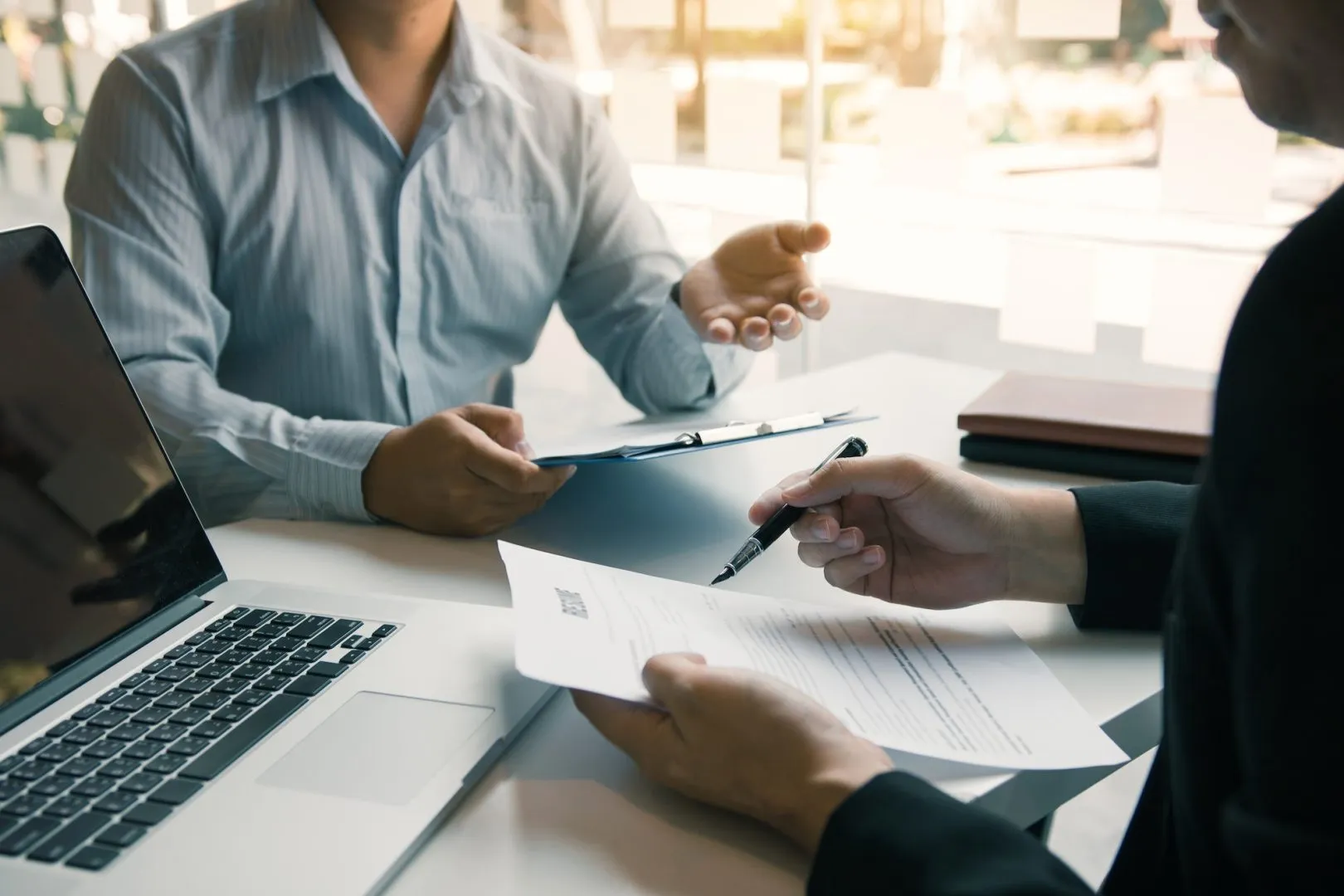 Job applicants are holding a resume document in the job interview room, job interview concept.